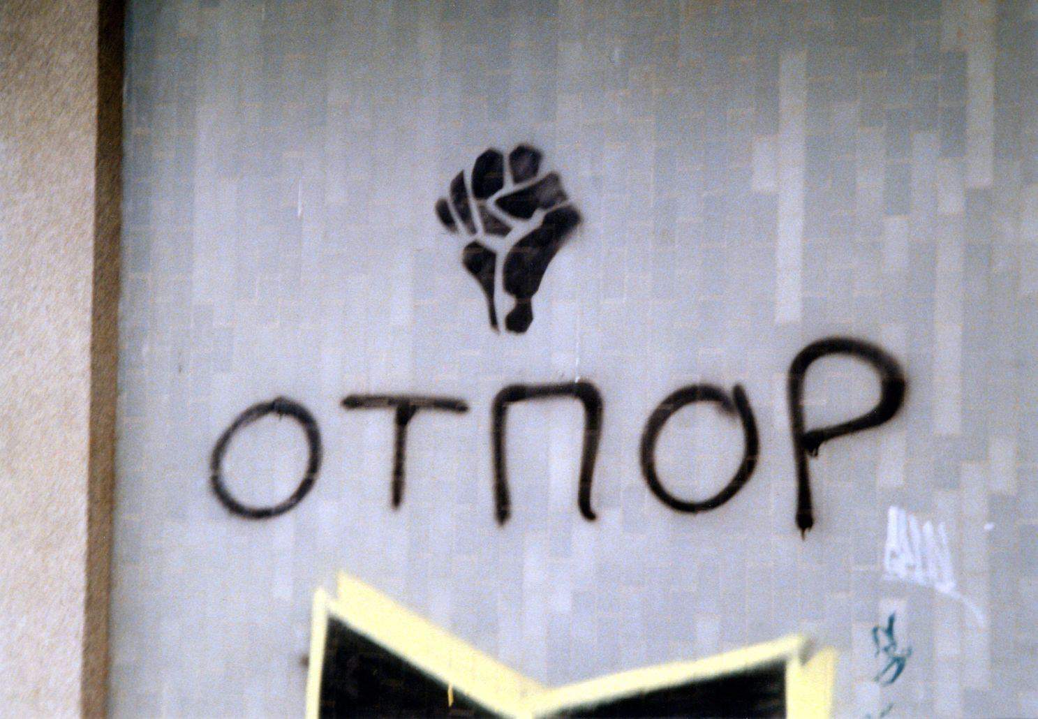 Stencil of OTPOR sign on wall with logo and writing that reads 'OTNOP'. [It is near the University of Novi Sad, Serbia, 2001]
