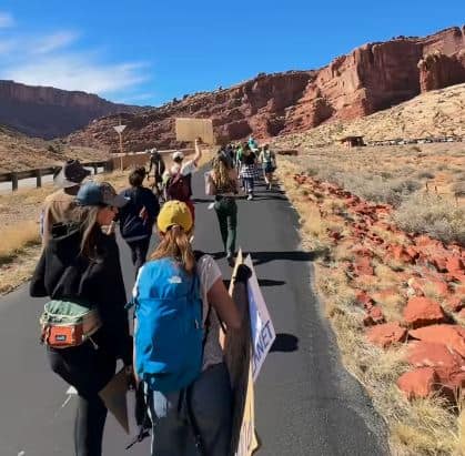 People marching towards a canyon