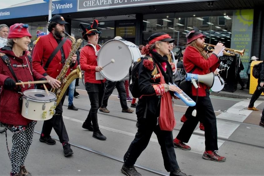 A marching band performs as part of a protest.