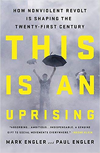 Cover of 'This is an Uprising'. Includes photograph of a person holding an umbrella surrounded by tear gas.