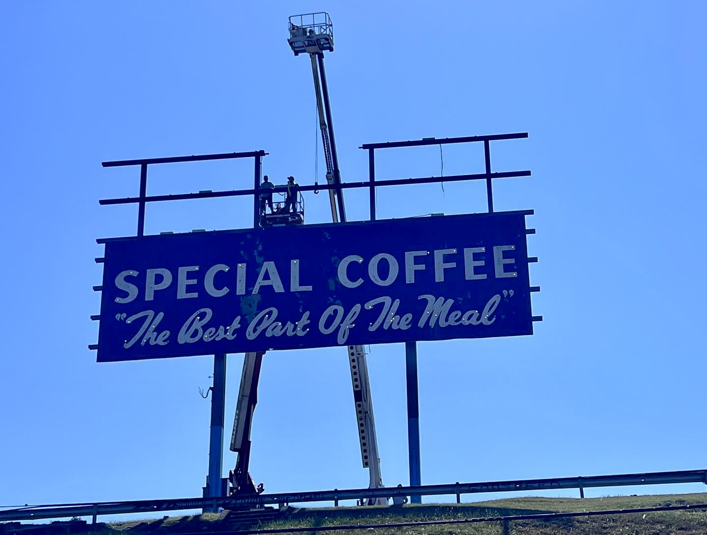 Photo of crews dismantling the JFG sign.