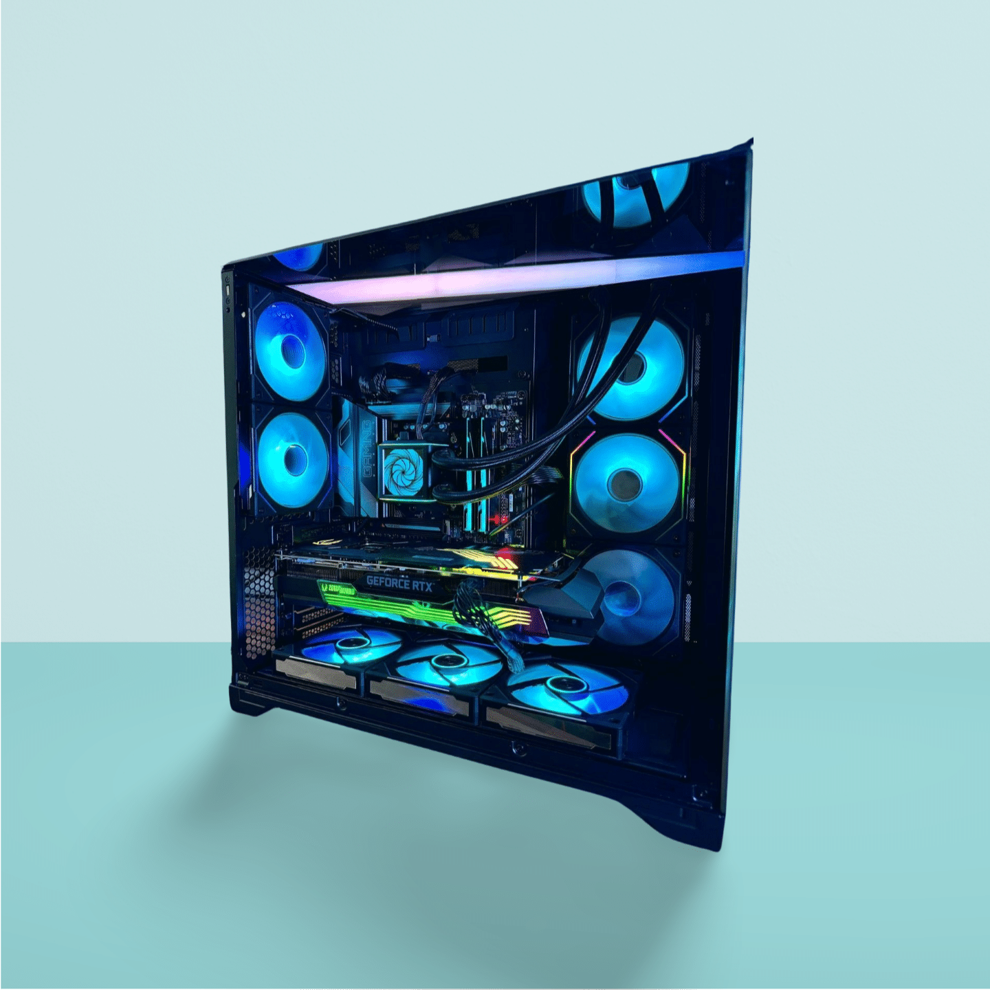 Sleek Espionage PC with vibrant RGB lighting inside a Lian Li O11 Vision Chrome case, showcasing its ZOTAC RTX 4070 Ti and liquid cooling setup