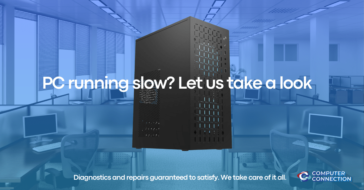 A sleek black PC tower with perforated sides on a blue-tinted office background with the text 'PC running slow? Let us take a look.