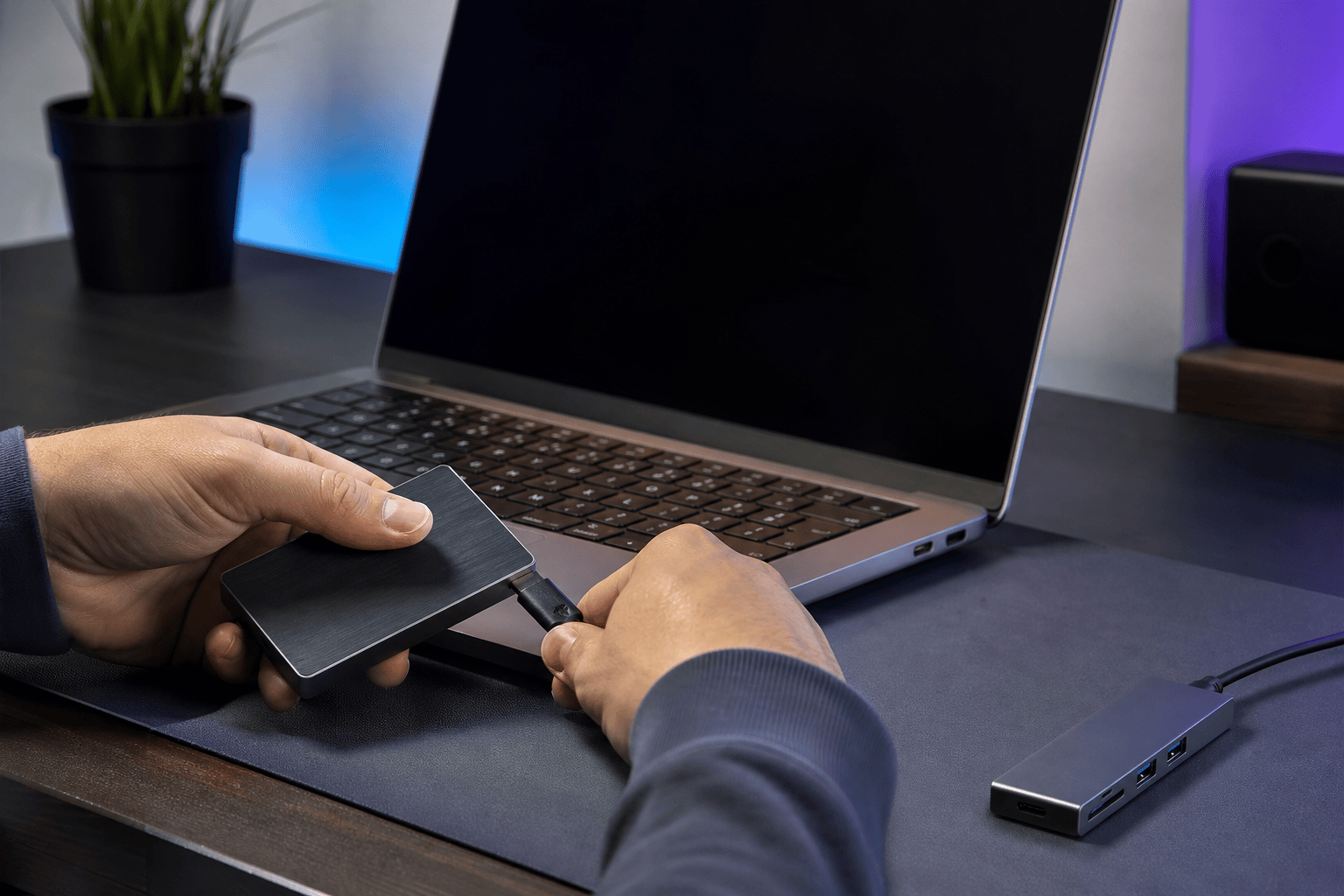 A USB device being carefully tested on a laptop in a home office