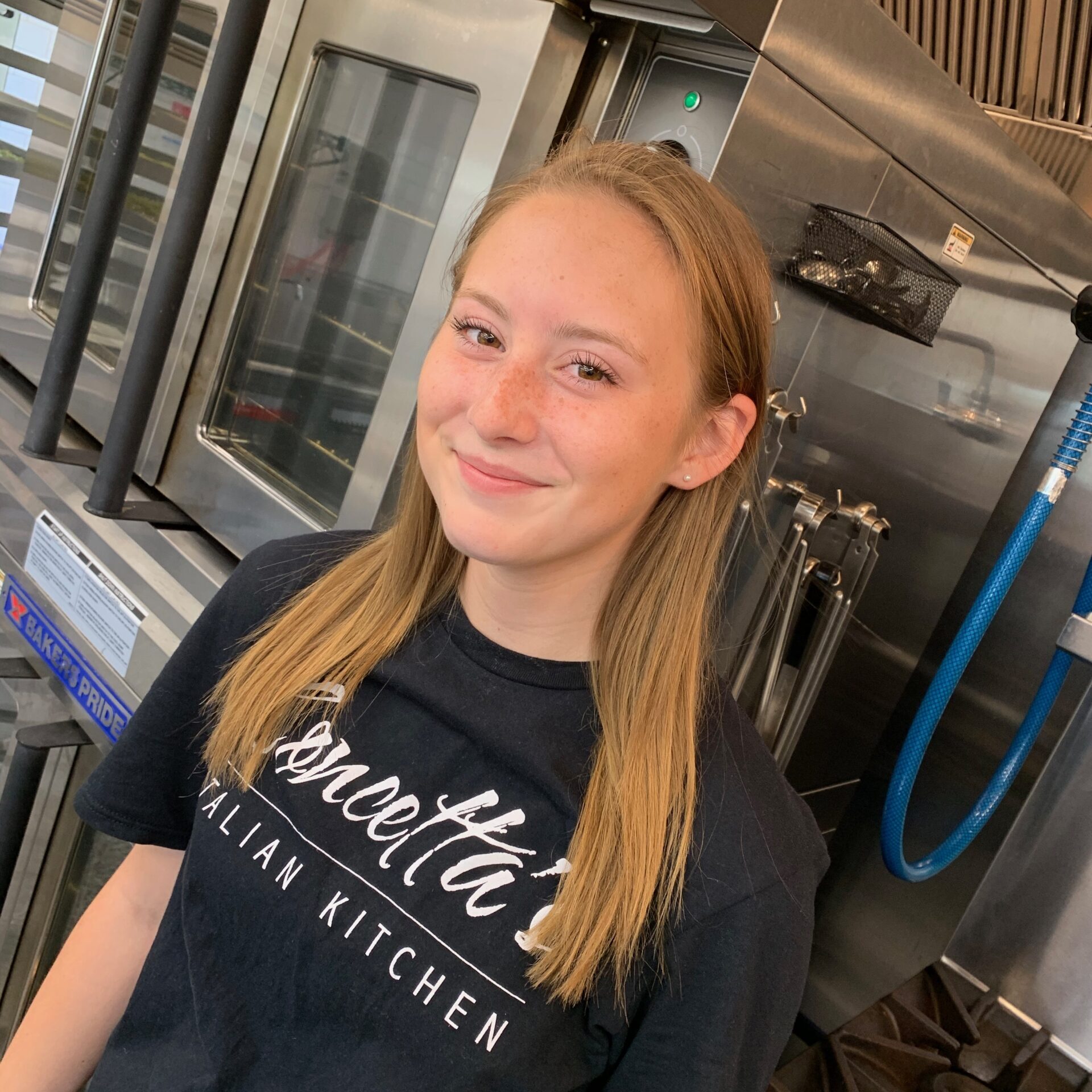 Smiling person in commercial kitchen