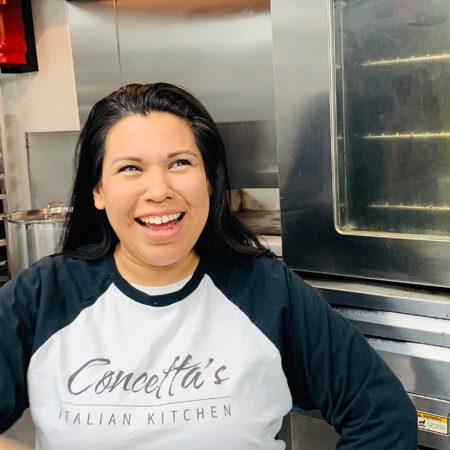 Smiling woman in restaurant kitchen