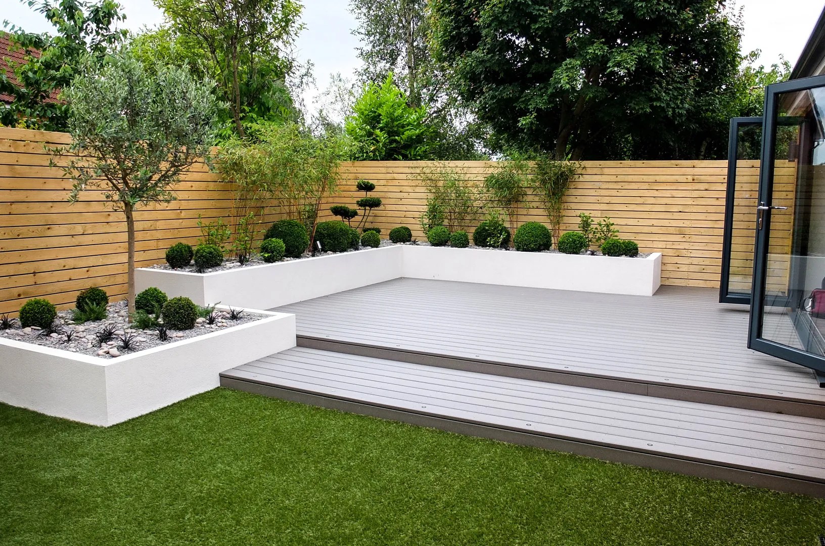 A beautiful low-maintenance garden with a mix of perennials, shrubs, and groundcovers, highlighted by mulch and drip irrigation.