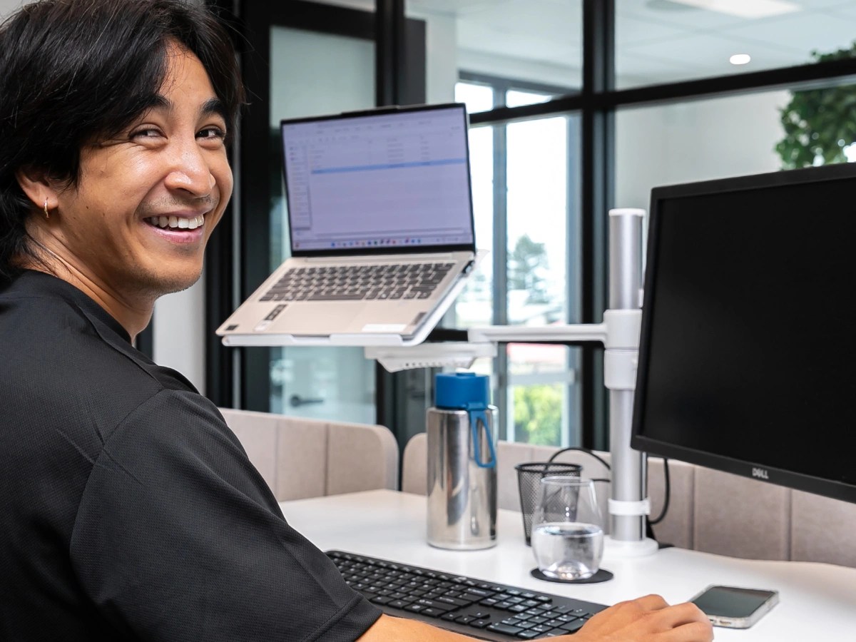 Connected Media Group team member working at his desk in the office