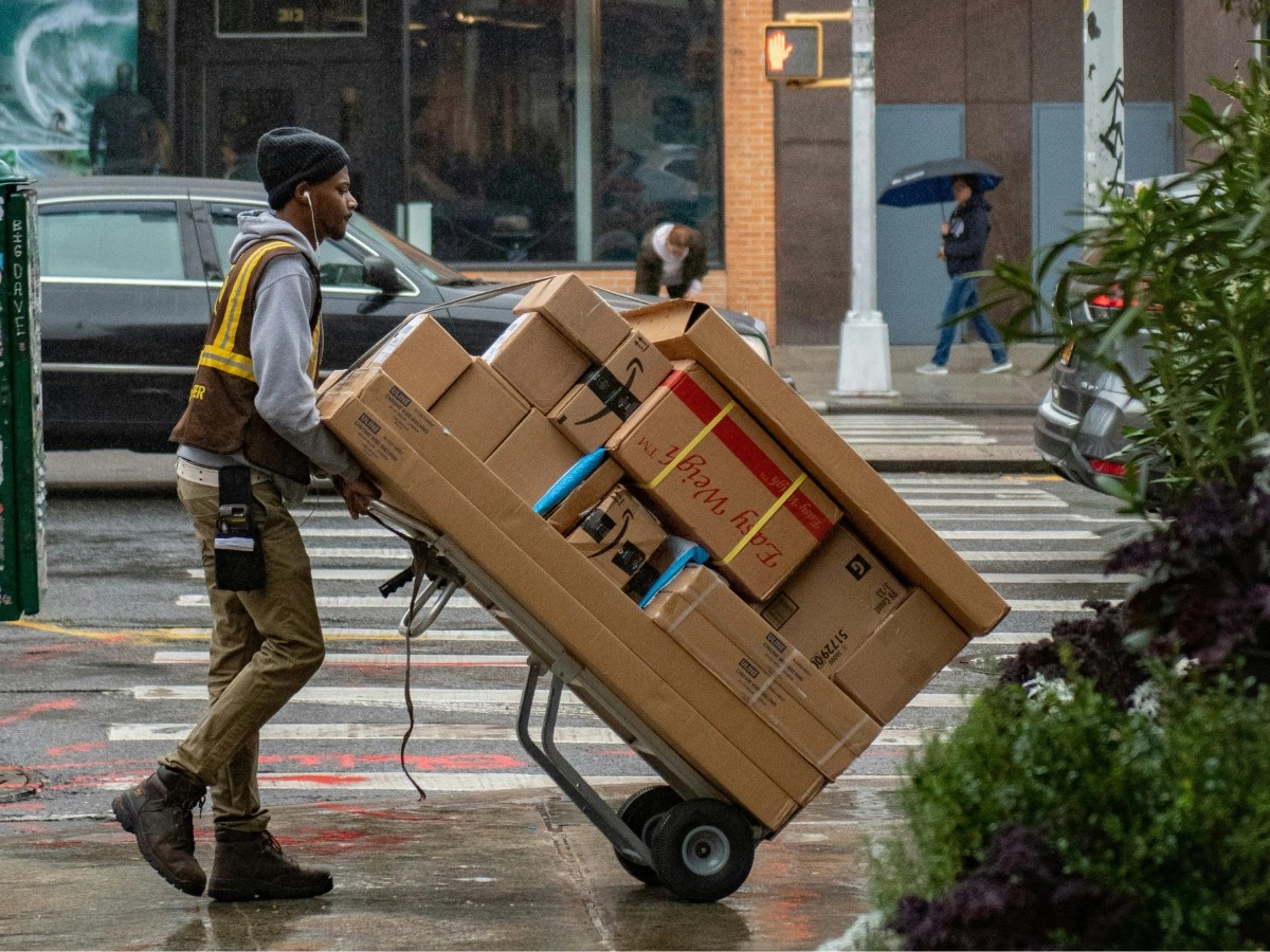 Amazon delivery worker transporting packages