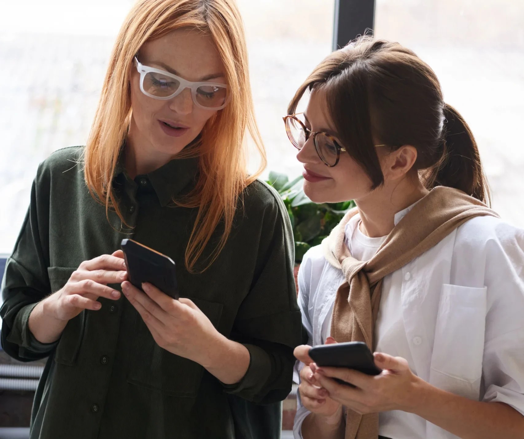 Marketing professionals using smartphones together