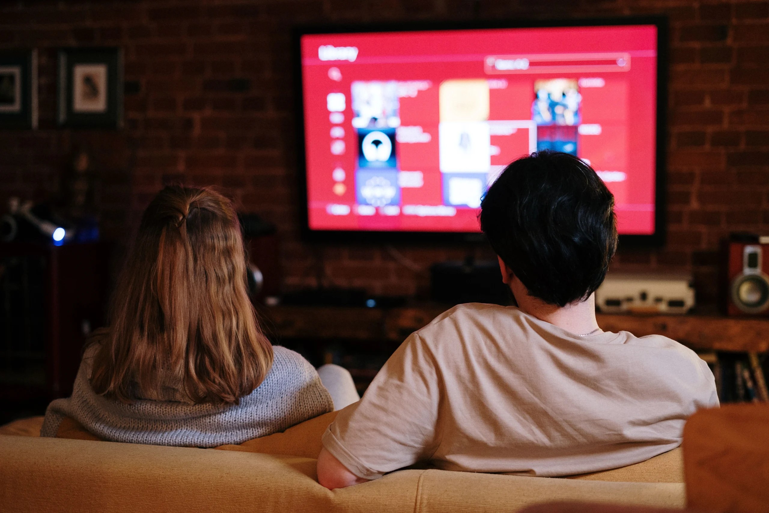 Couple watching online video advertising on a television