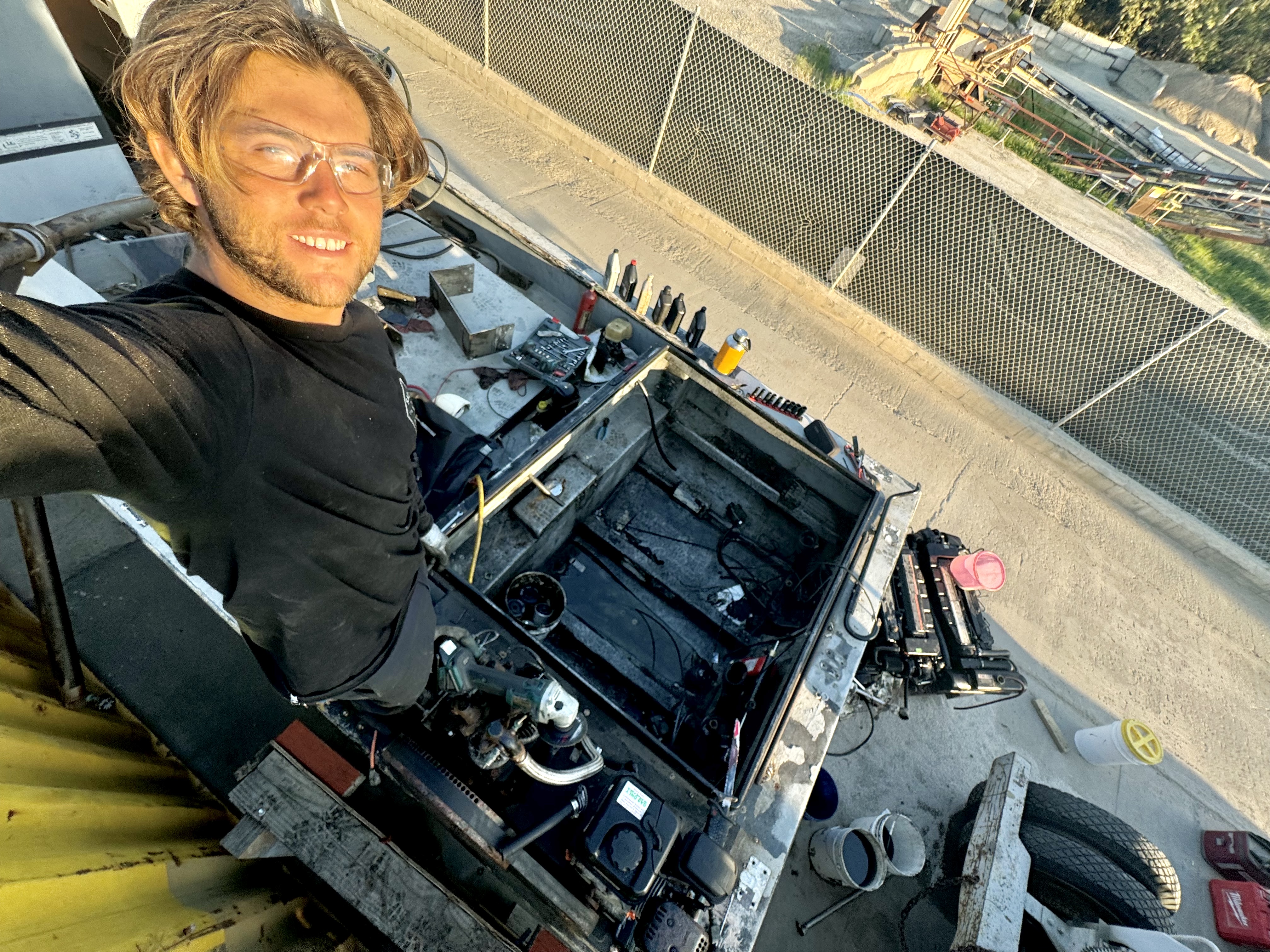 Conner Coffin standing on top of a dirty engine box where the motors used to be.