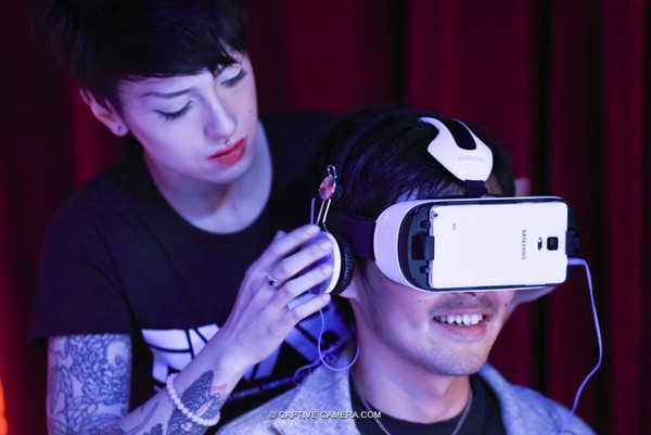 An attendant helps a patron with a Samsung Gear VR at FIVARS in Toronto, 2015