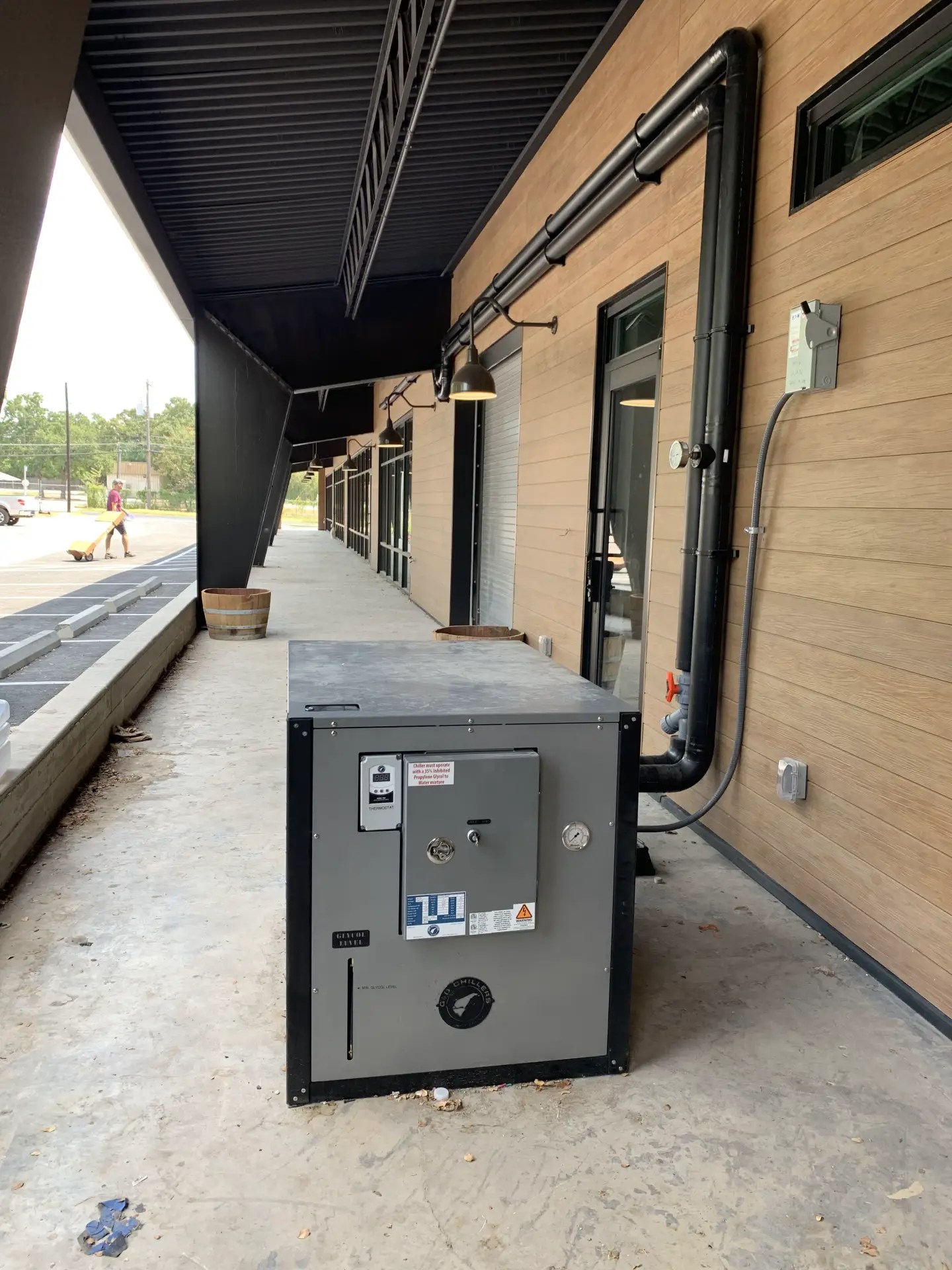 Packaged outdoor chiller with a digital controller and control panel beside insulated glycol piping