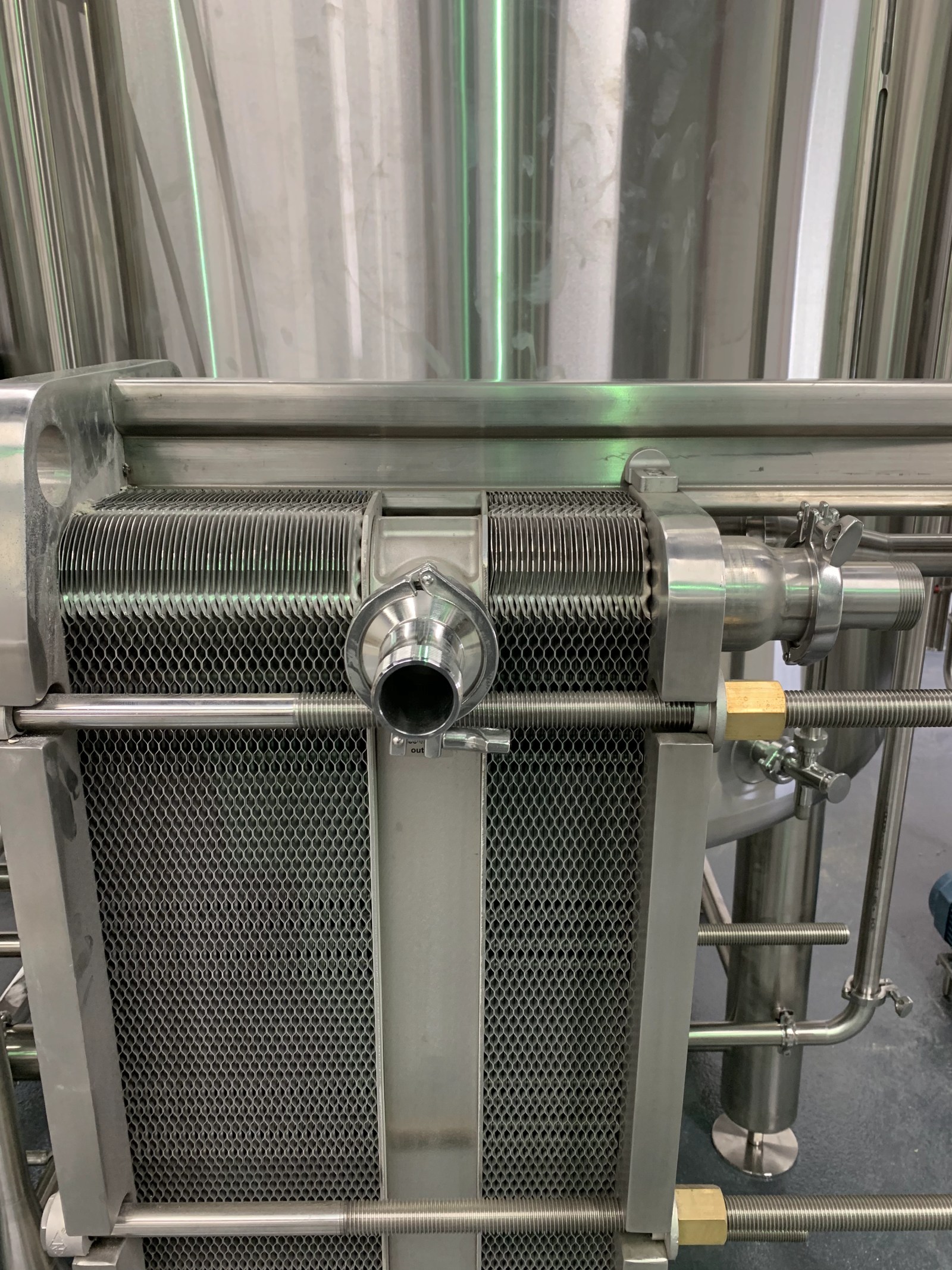 Close view of a plate heat exchanger frame and its port connections
