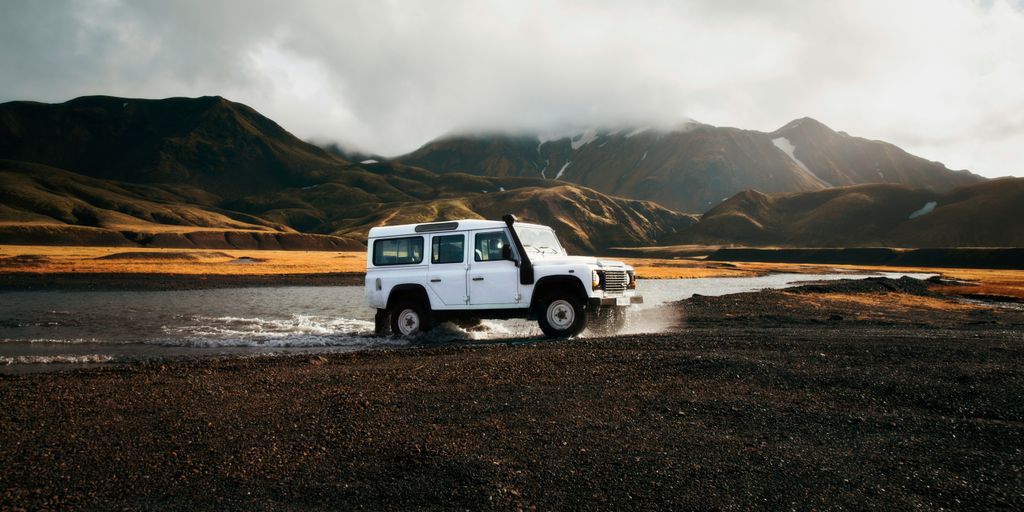 white car crossing body of water