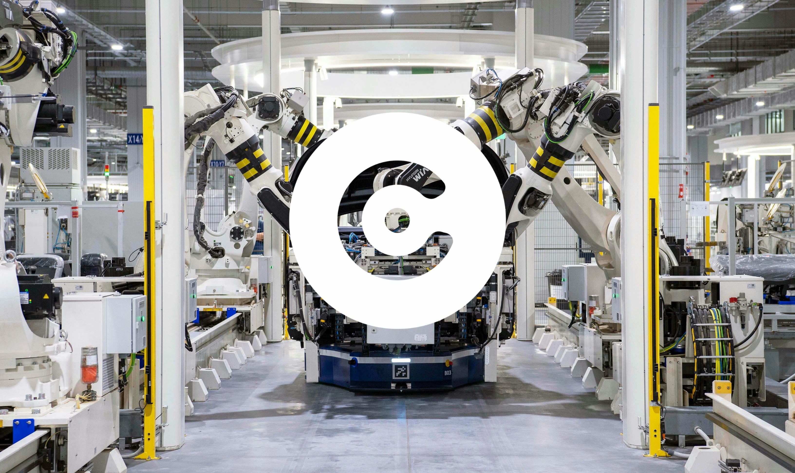 Industrial robots assembling components on an automated production line inside a modern factory.