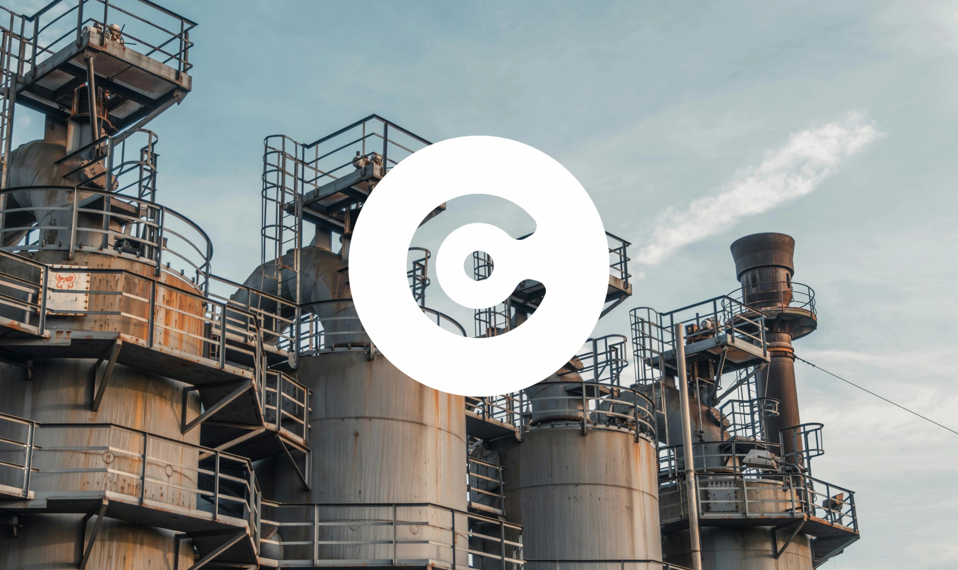 Factory containers photo with a bold white circular logo with a "C" shape is overlaid in the center of the image.