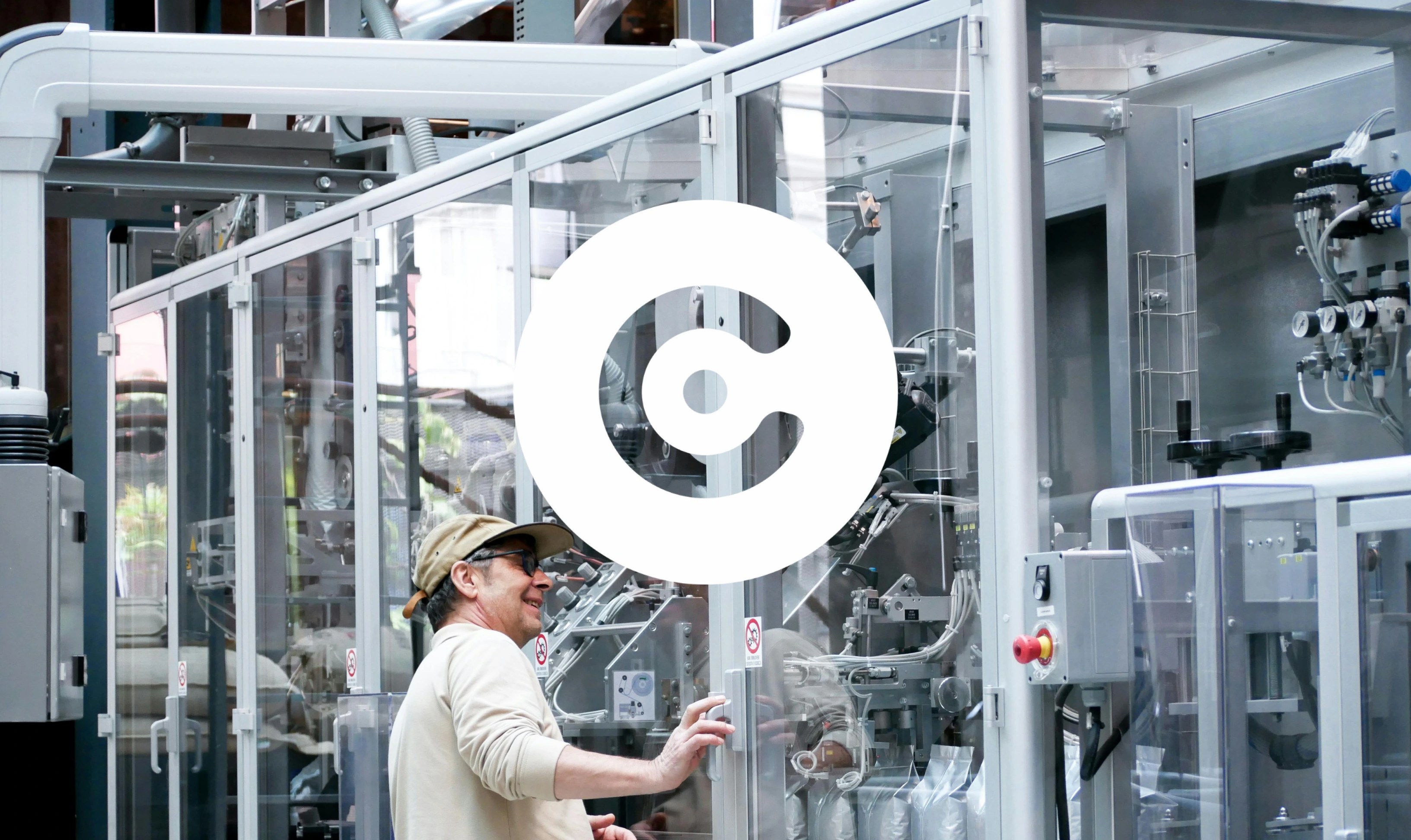 Alttext generator said: Man operating industrial machinery in a factory setting.