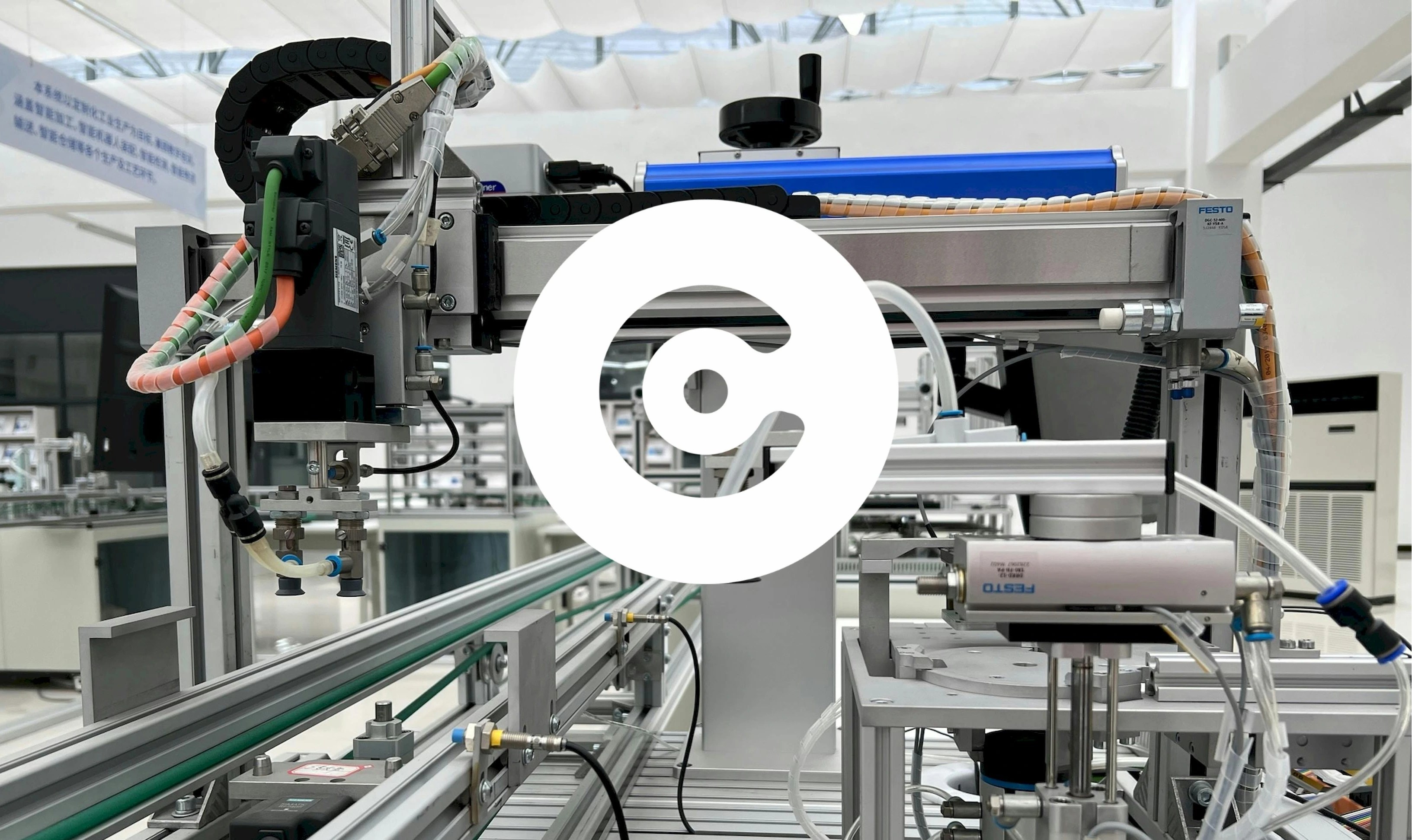 Close-up of automated industrial equipment with cables and metal components in a clean factory.