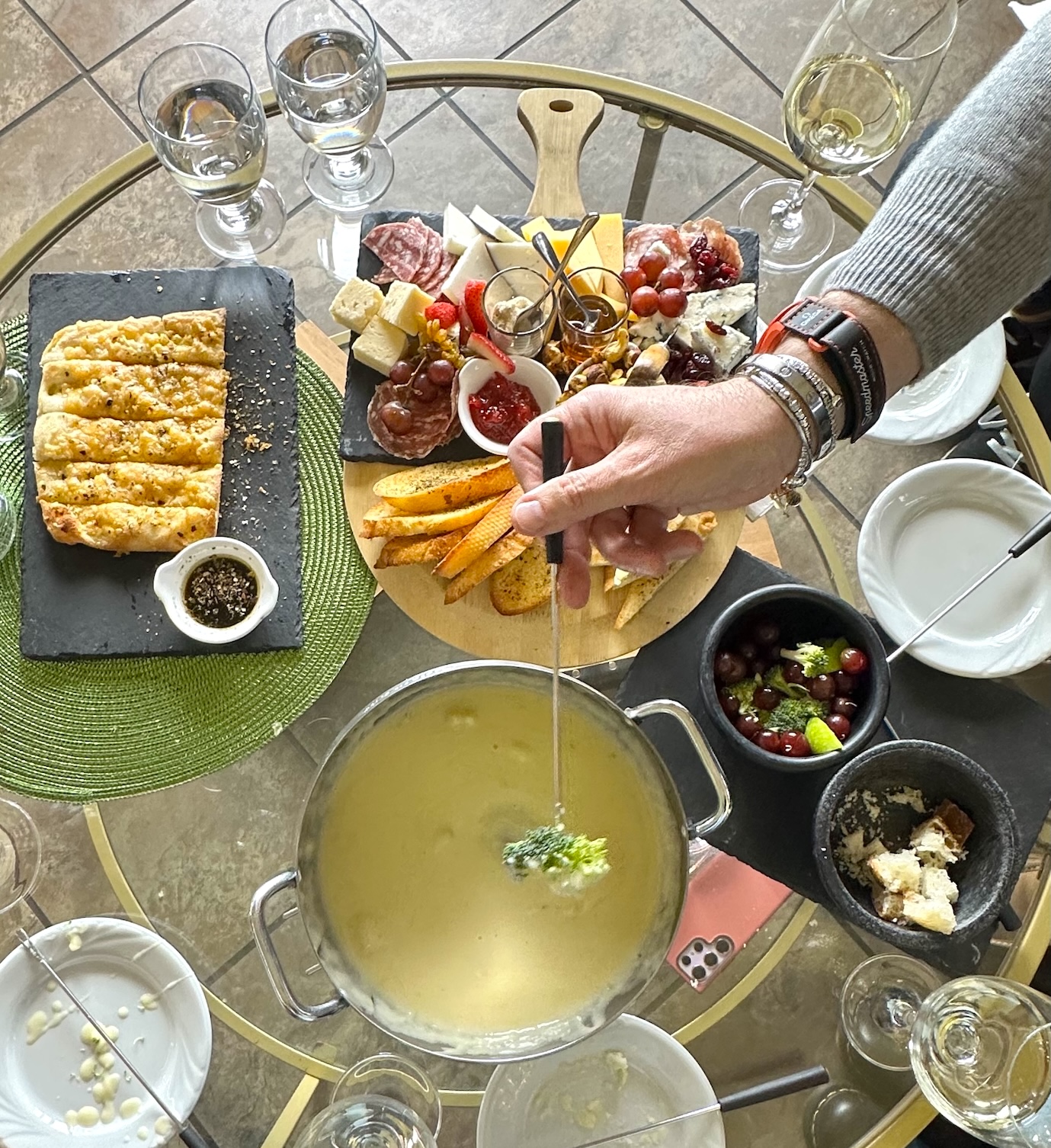 Dipping broccoli into the Swiss Cheese Fondue