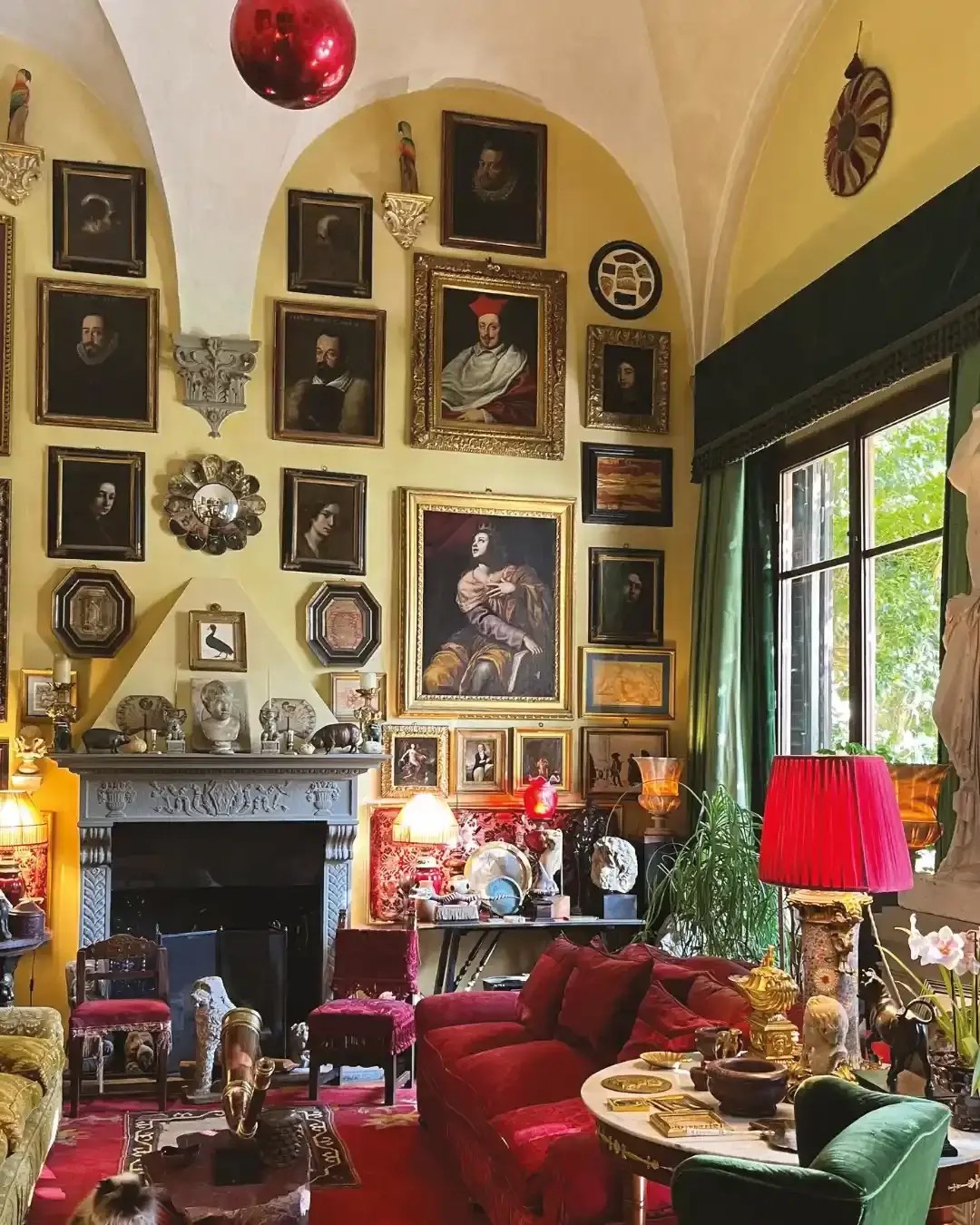 a room with a fireplace and pictures on the wall for corinna experiences