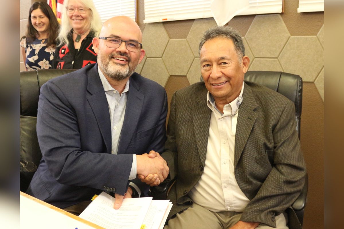 Jason Casuga, left, CEO and chief engineer for the Middle Rio Grande Conservancy District, and Felix Chaves, right, Governor of Sandia Pueblo shake hands Sept. 25 after signing an agreement that will allow repair work on the Corrales siphon to proceed. The MRGCD recognized the siphon had not received proper right-of-way permits from the Pueblo, which meant the district had been trespassing on Pueblo lands for nearly 100 years.