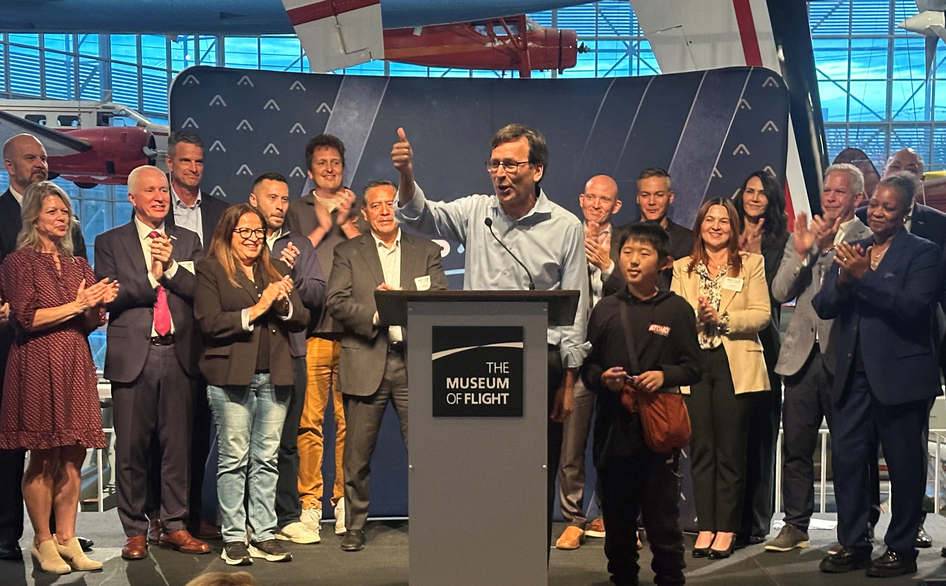 Gov. Bob Ferguson surrounded by Washington Space Council members at Museum of Flight