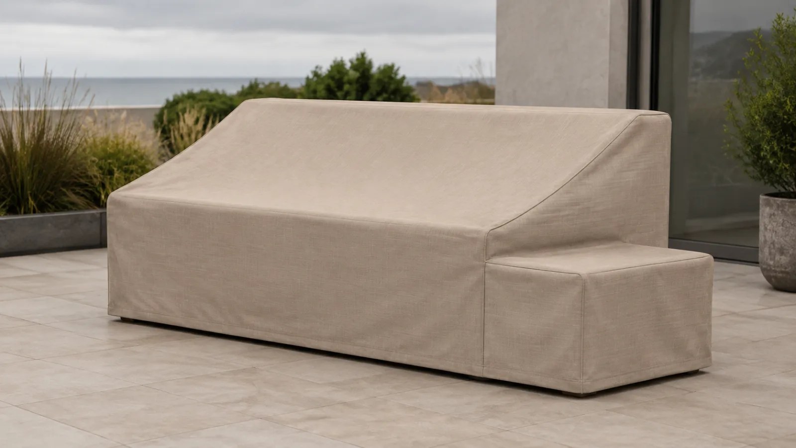Tailored sand-colored cover over an outdoor sofa with a built-in side table