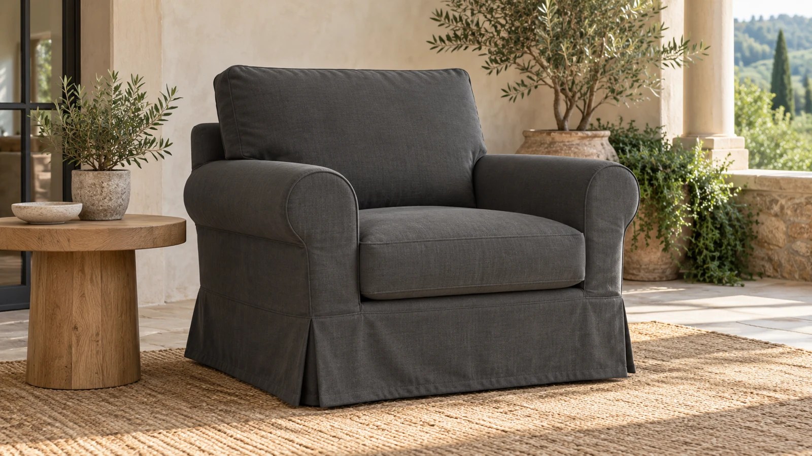Tailored charcoal single-seater sofa slipcover with fitted arms, seat deck, back, and short structured skirt