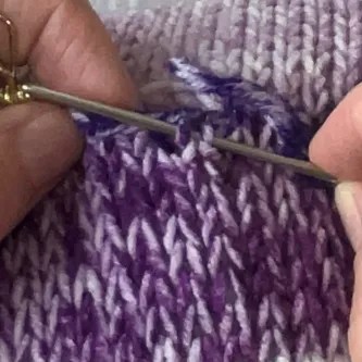 a knitting needles showing how to do an invisible seam