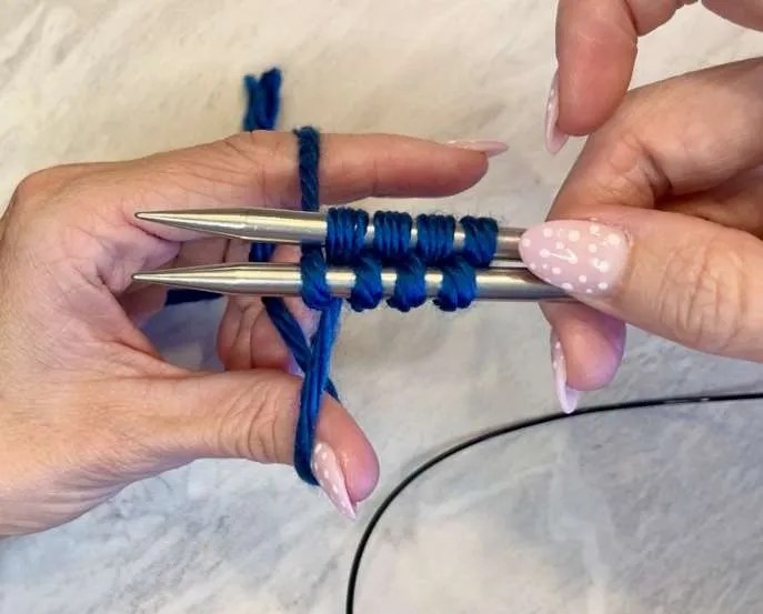 Alternating yarn wraps between top and bottom needles while doing Judy’s Magic Cast-On for knitting