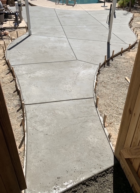 Freshly poured concrete sidewalk during installation