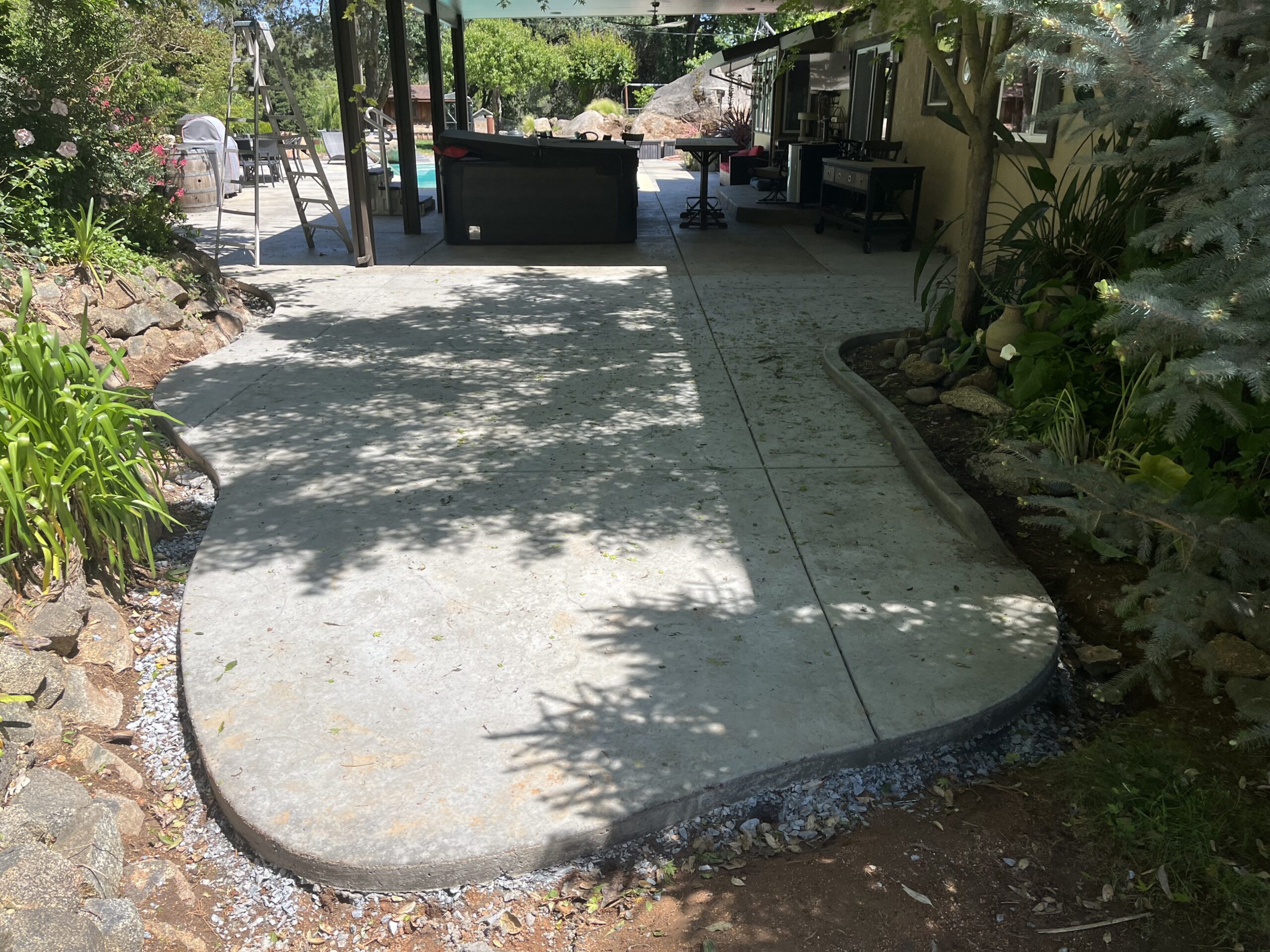 Finished concrete patio in residential backyard
