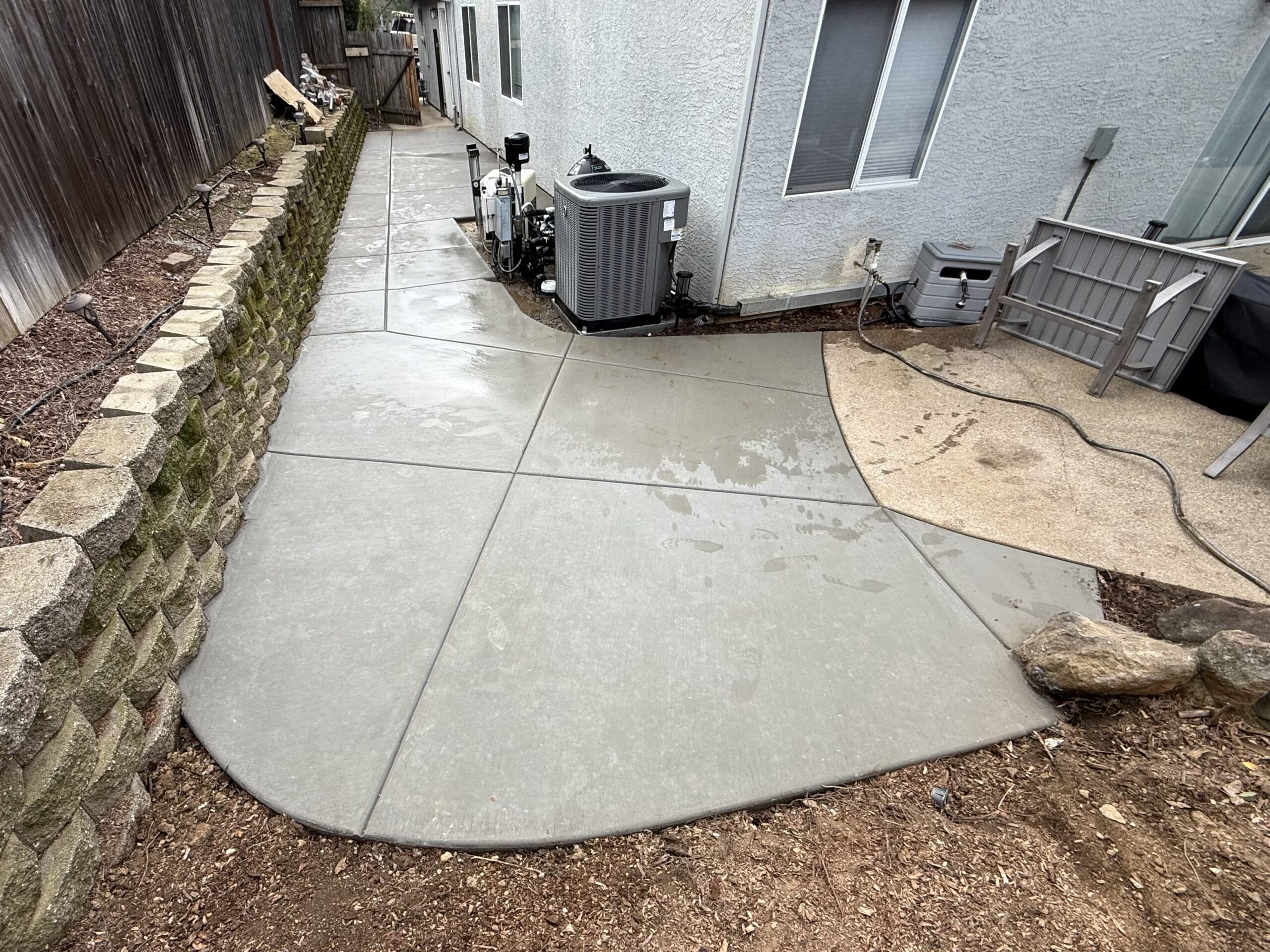 Concrete extended patio connecting to the backyard