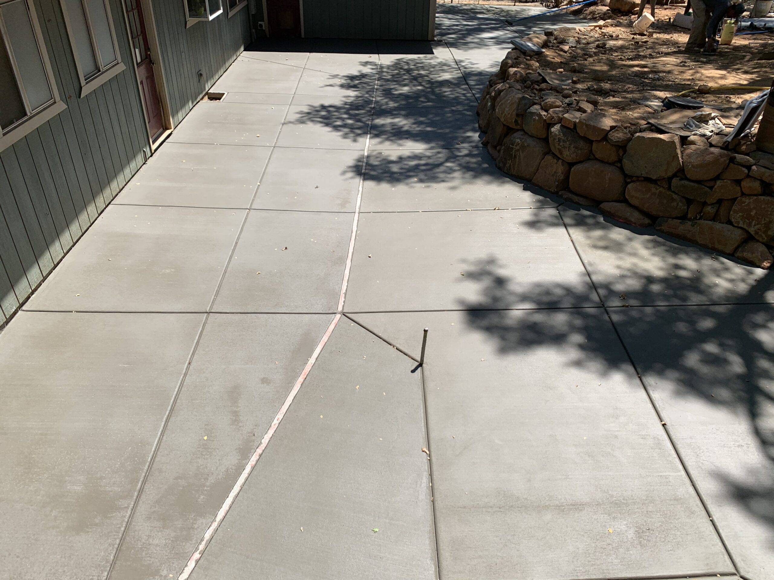 Backyard concrete patio designed for outdoor seating