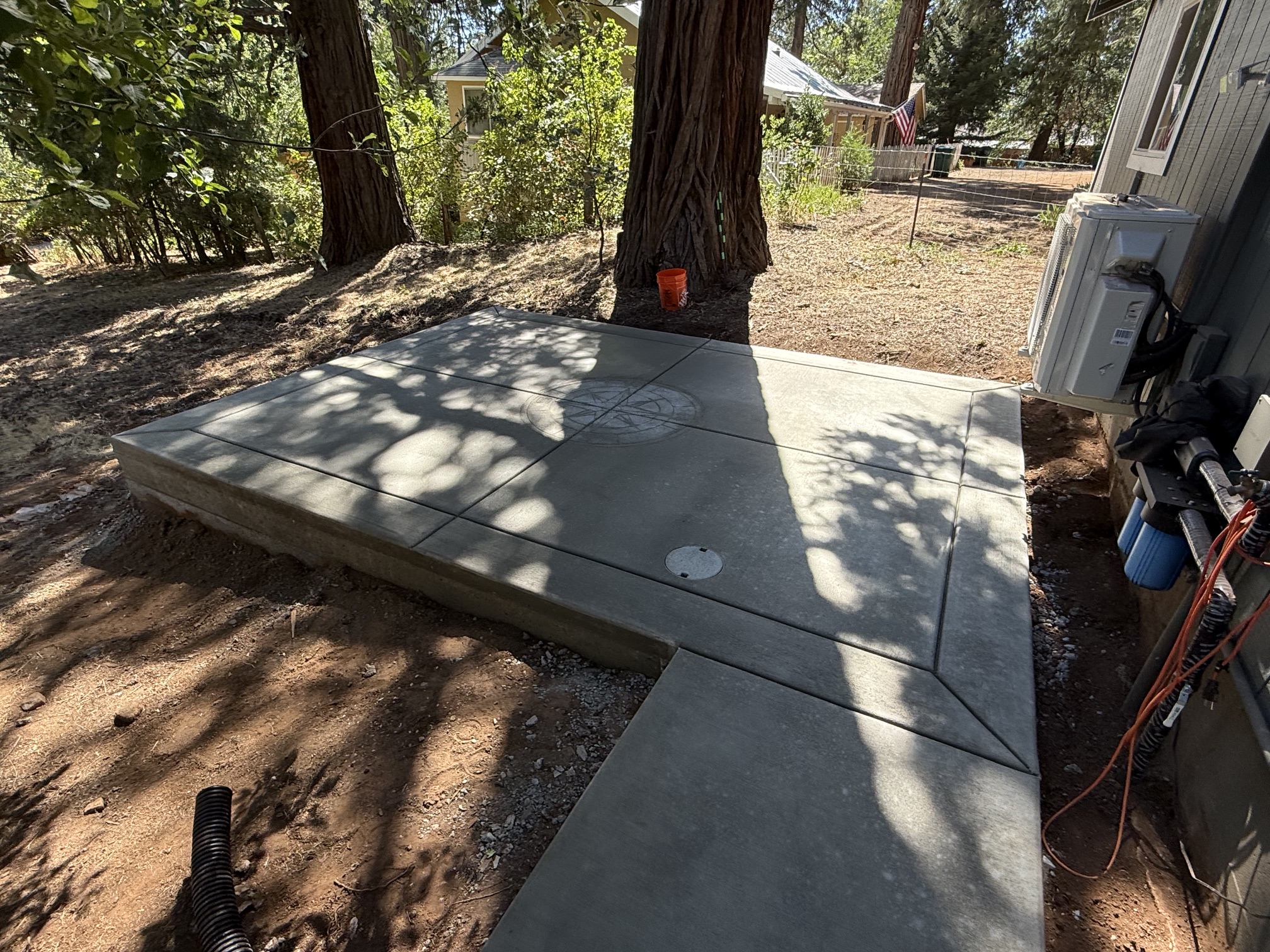Backyard concrete patio designed for outdoor seating