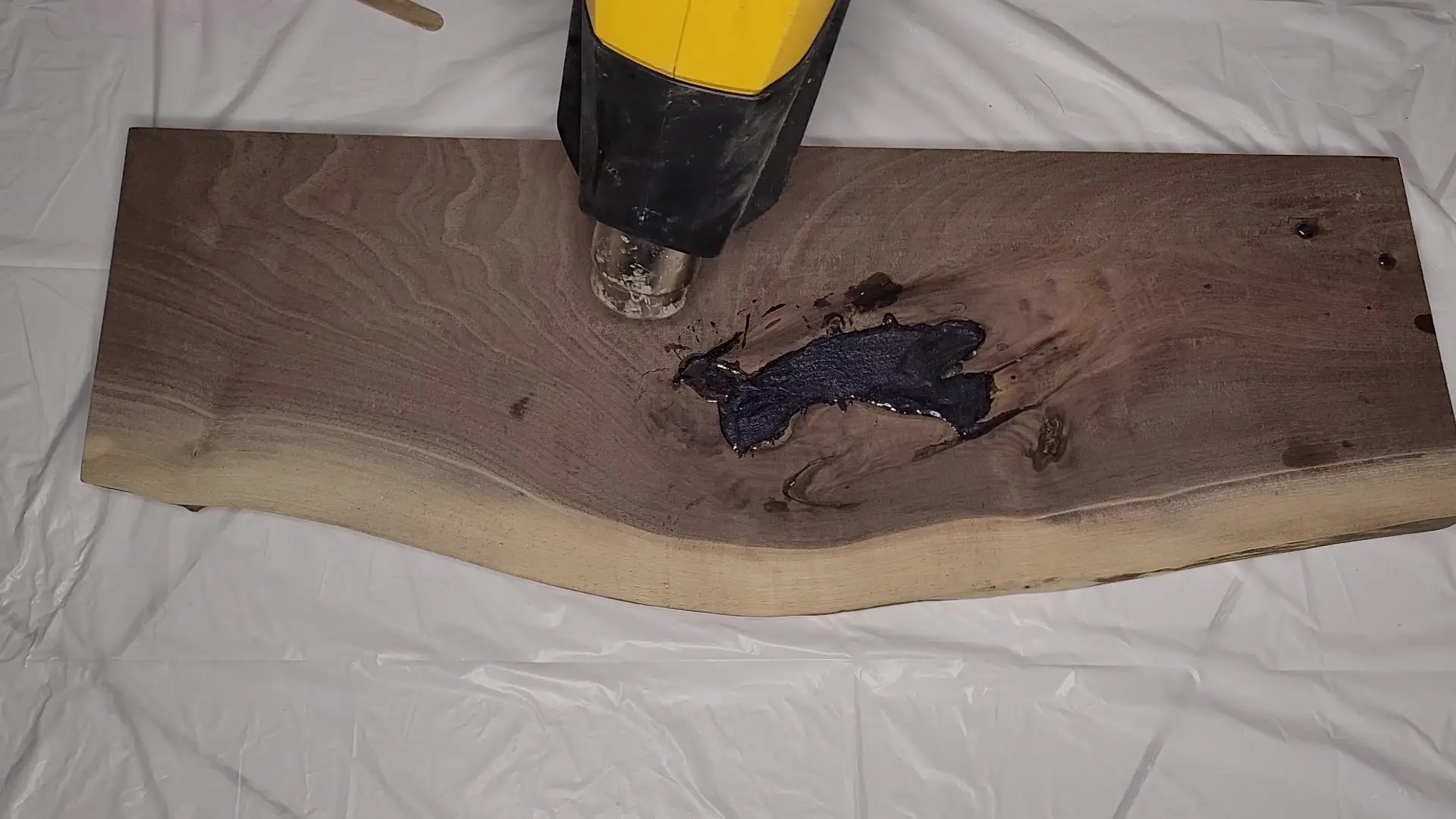Knot hole fill with black and purple epoxy