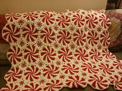 Here is a roundup of free crochet blanket, throw, and afghan patterns to make for Christmas curated by Crafting Happiness.