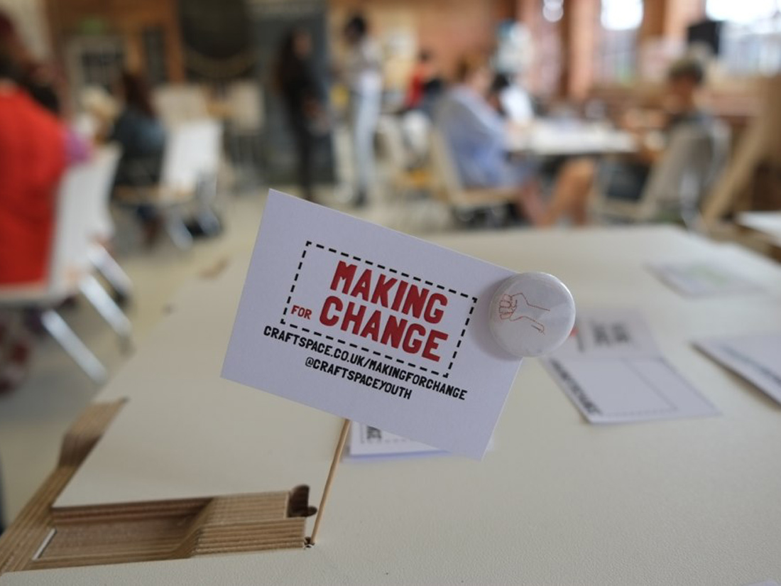 Making for Change card and small badge with drawn stitch fist logo