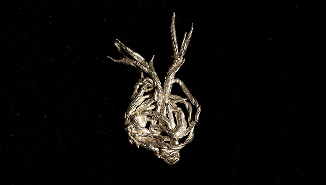 An abtract metal form made of twisted branchlike forms.