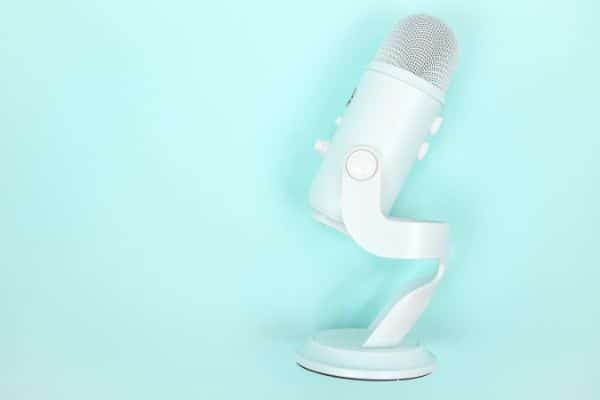 mint background with white mic. Calgary Digital Marketing agency offers a variety of tactics.