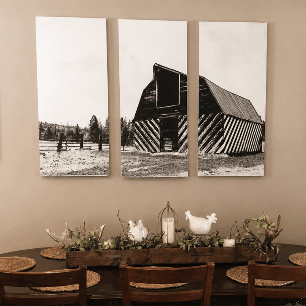 Rustic Farmhouse Dining Room Table with a Picture of a Black and White Barn on the Wall.