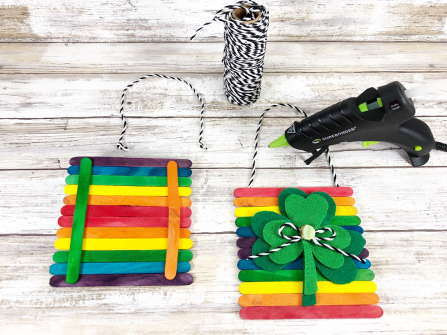 Adding baker's twine bows and buttons to embellish centers of felt shamrocks