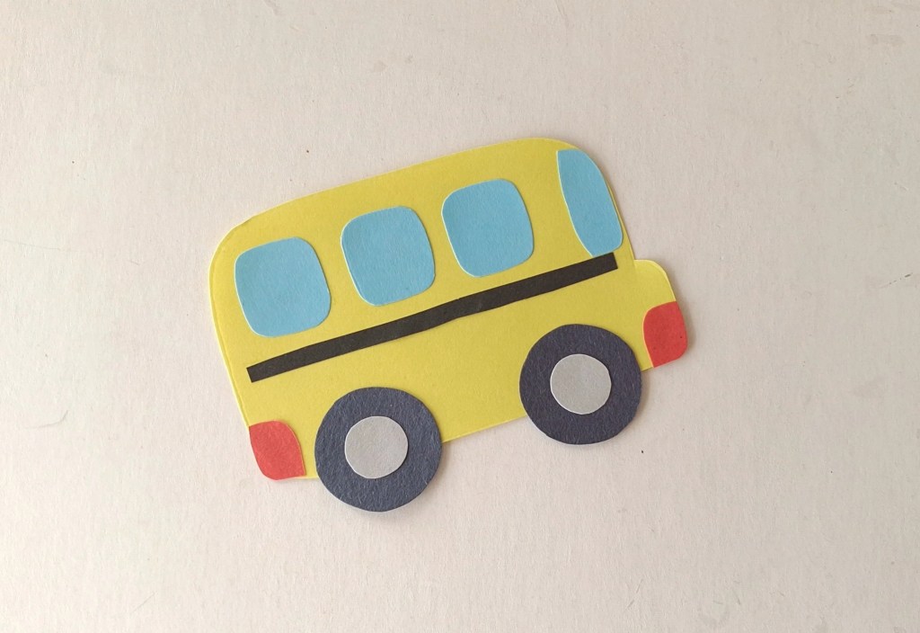 Finished paper school bus with wheels attached and ready to add to the moving craft.