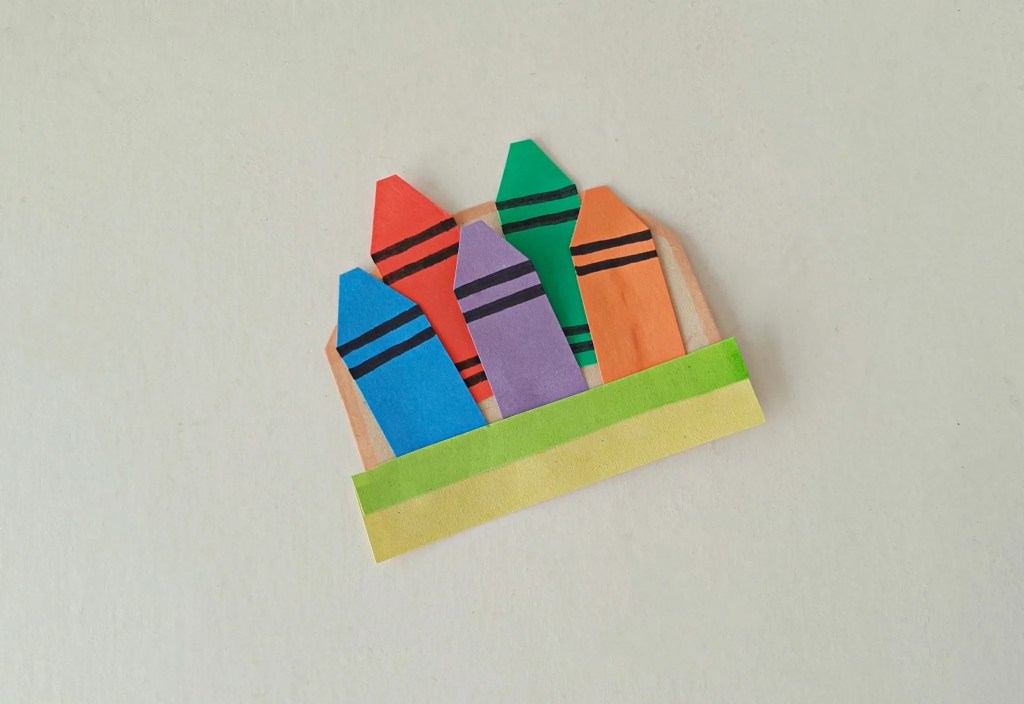 .Paper strips glued to the completed crayon holder