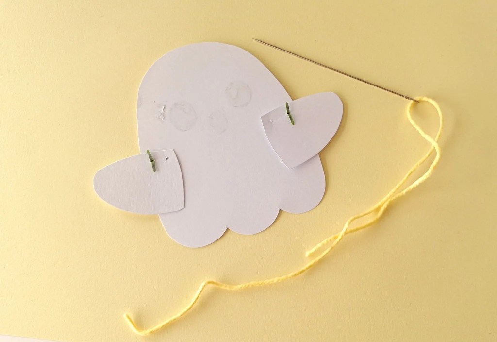 Both paper arms attached to the back of the moving ghost puppet