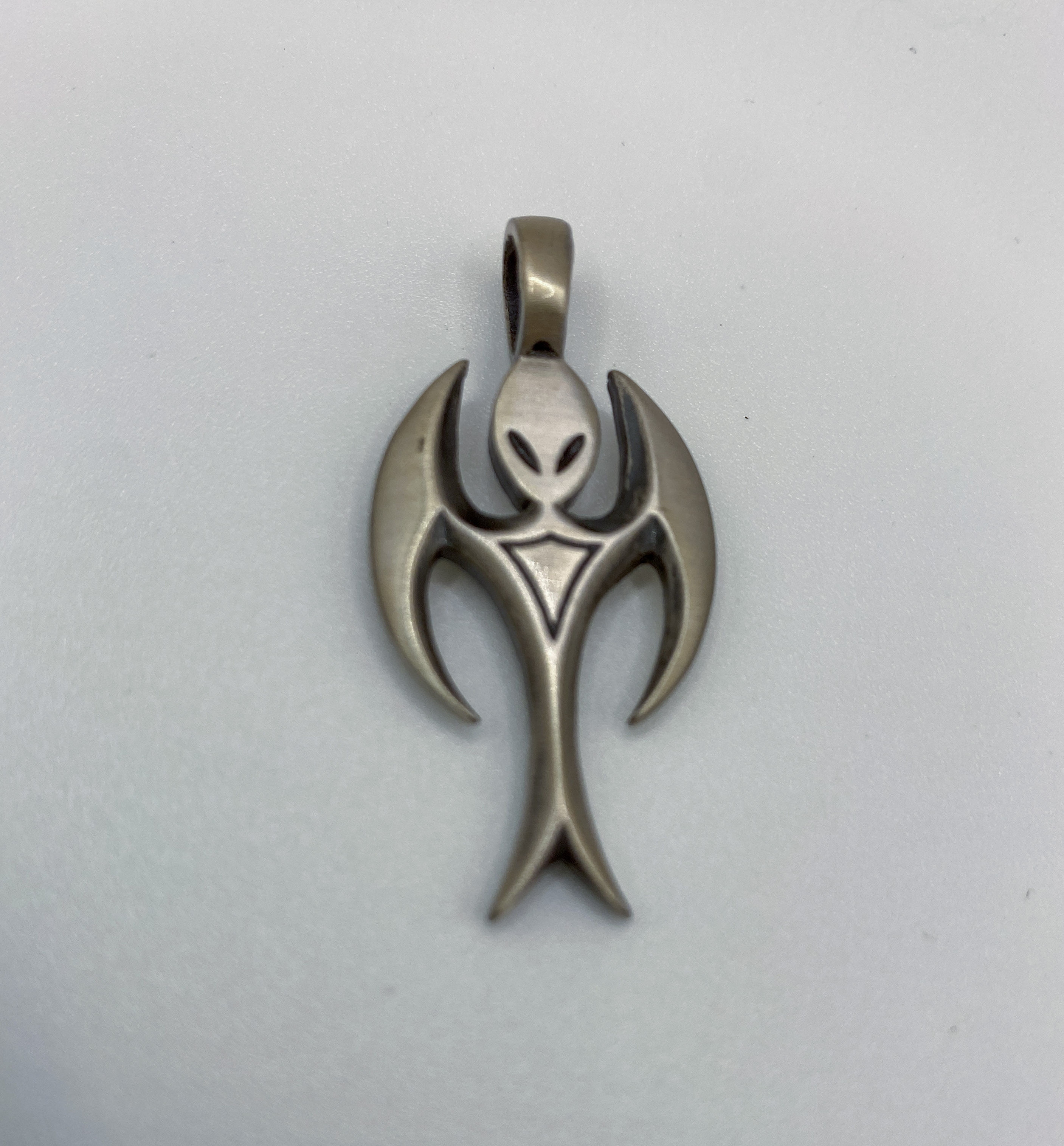 Silver-plated pewter pendant shaped like an alien with angel wings