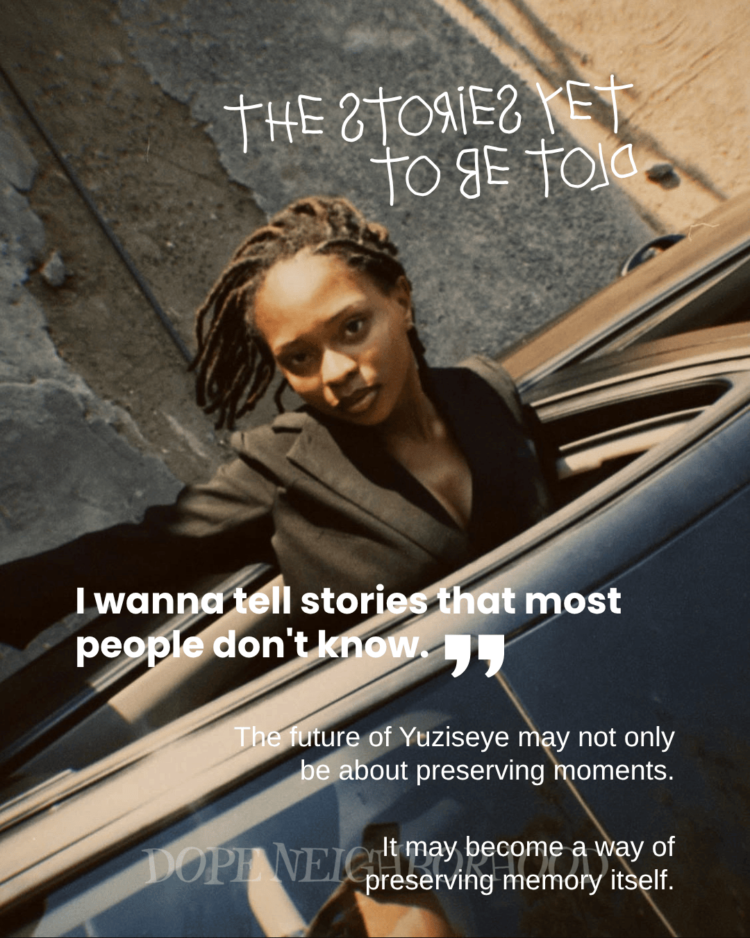 A woman with locs wearing a black blazer looks directly at the camera from the driver’s seat of a car, with urban surroundings in the background. The image features text about storytelling and preserving memories.