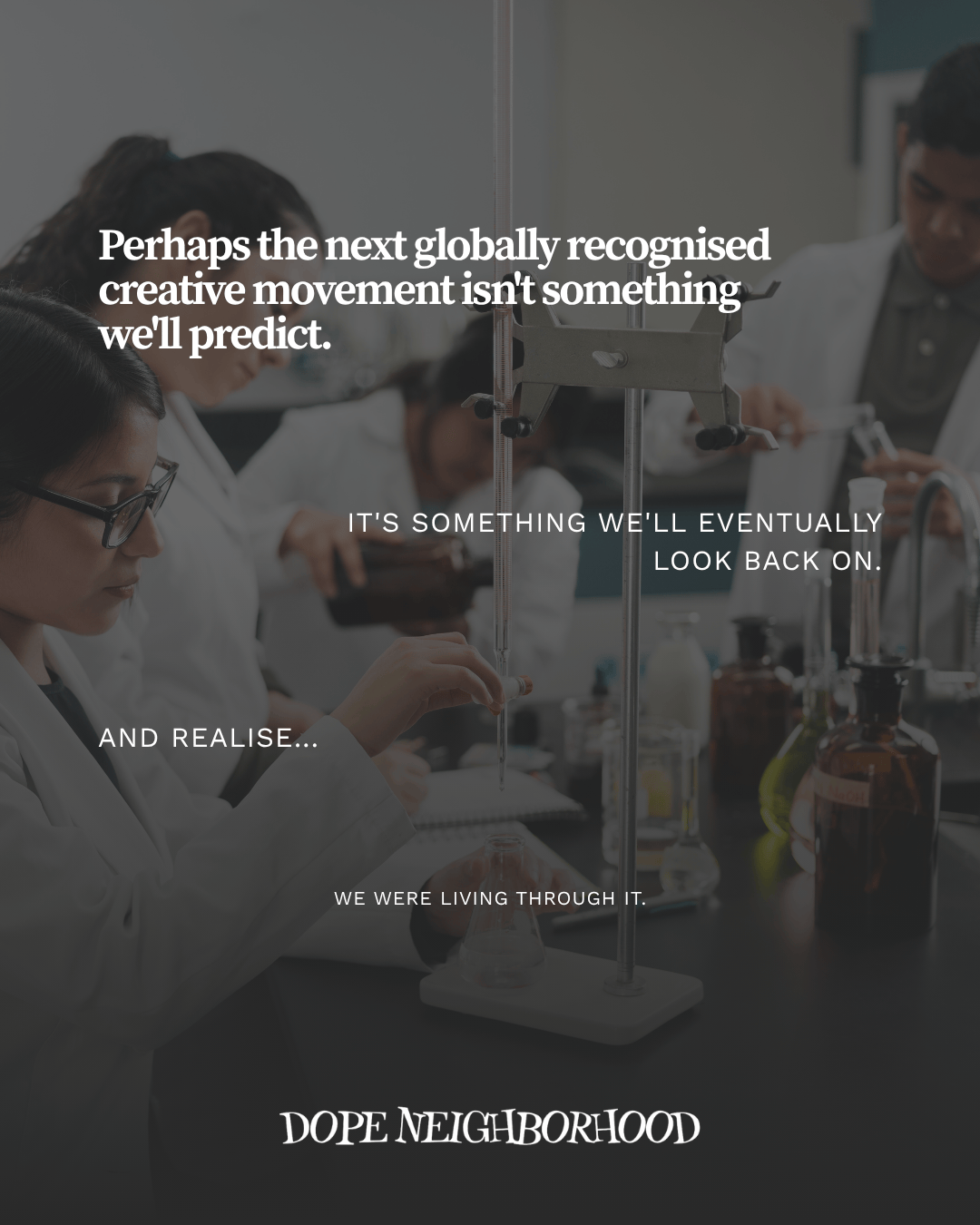 A laboratory scene featuring individuals in white lab coats conducting experiments. There are various laboratory glassware and equipment in use, with a focus on collaboration and creativity in a scientific environment.